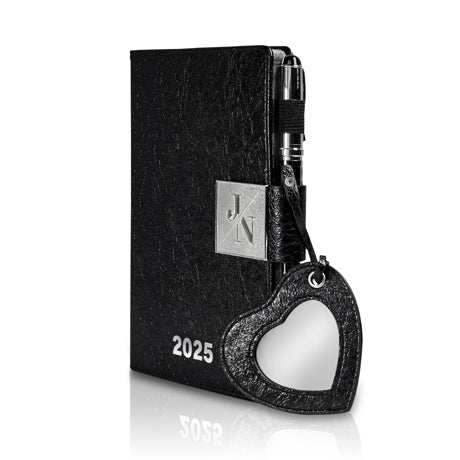 Luxury 'Agenda 2025' planner in black leather with heart-shaped mirror pendant and silver accents.