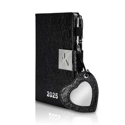 Luxury 'Agenda 2025' planner in black leather with heart-shaped mirror pendant and silver accents.
