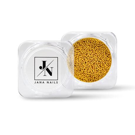 Perles de Caviar Gold for nail decoration in a clear container.
